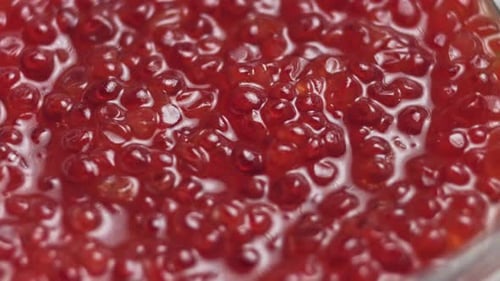 Red Caviar Rotated Over Black Background