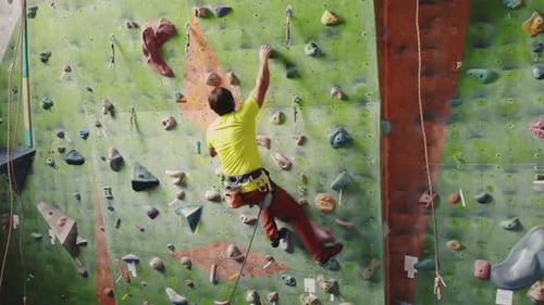 Adult Climbing on an Indoor Rock Climbing Wall