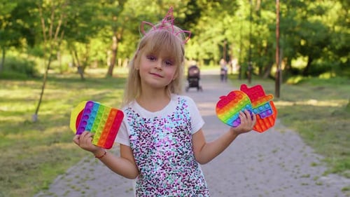 Female Child Girl with Push Pop It Bubble Fidget Stress Anxiety Relief Squeeze Sensory Game Toys