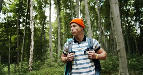 Backpacked Male Walking in Forest