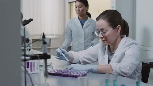 Woman Scientist Working in a Bright Lab