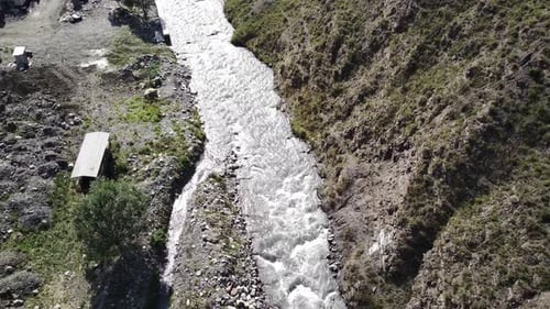 Close Up of Waterway Flowing in Mountainous Area. Mountain River Flows Through Summertime