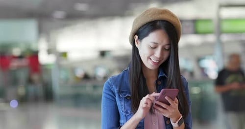 Woman search on mobile phone in the station