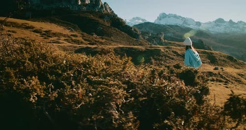 Inspired Female Traveler Climbing on Hill at Springtime Mountain Journey