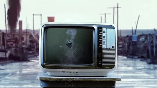An Old TV with Green Screen Exploding on the Street in a Ghost Town.