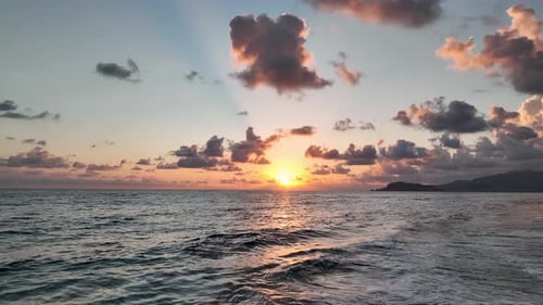 Beautiful cloudy sunset over the sea aerial view 4K