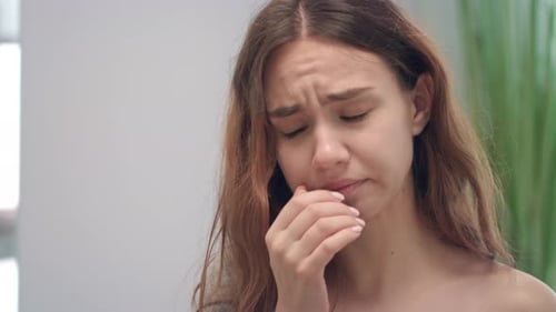 Unhealthy Young Girl with Runny Nose While Cold Disease Sneezing in Handkerchief