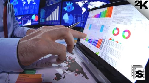 Business Professional Analyzing Charts in Modern Office