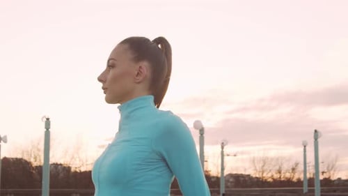 Woman Warming Up Arms and Shoulders on Rooftop