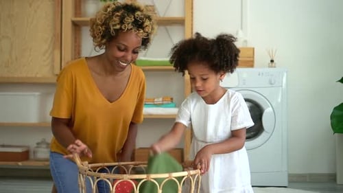 African American Mom and Daughter Do Domestic Chores Prepare Laundry for Wash Spbd
