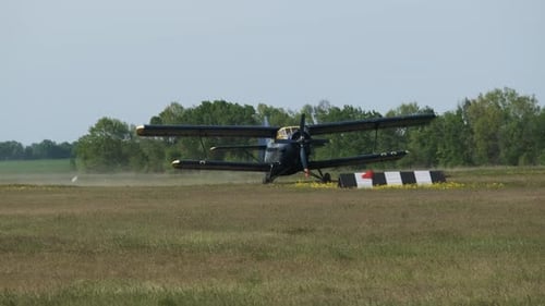 Small Old Propeller Plane is Moving Towards the Runway in Field After Landing
