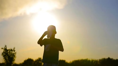 Child with Paper Airplanes Silhouette at Sunset