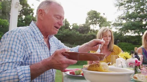 Family Gathered at Outdoor Dinner Table