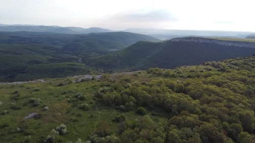 Aerial View of Rolling Green Hills and Mountains