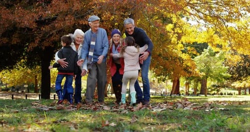 Happy Family Embrace Outdoors in Autumn Park