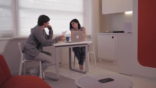 Couple Discuss Finances at Table Indoors
