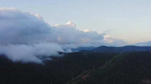 Majestic Mountains with Clouds and Transmission Towers