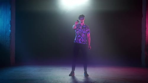 Adult Using VR Headset and Controllers in Dark Room
