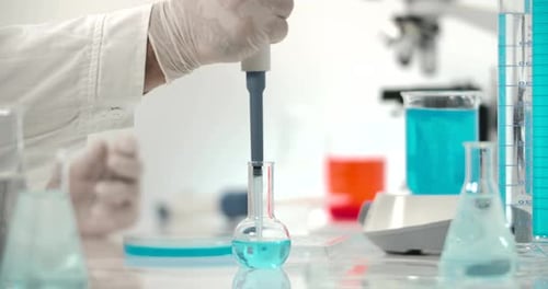 Pipette Transfers Liquid in Lab Beaker
