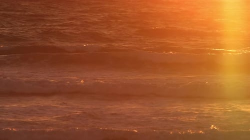 Sunset Lit Ocean with Waves Rolling with a Peak of the Sunset