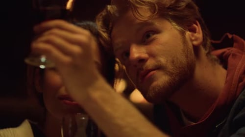 Man and Woman Chat and Drink Wine Indoors