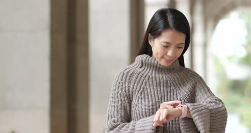 Young Woman Uses Smart Watch Outdoors