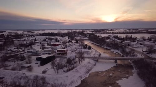 Still aerial view of the sunset over a sleepy small town at sunset