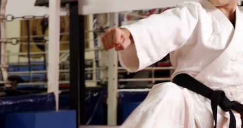 Man in Gi Kicks in Gym Boxing Ring