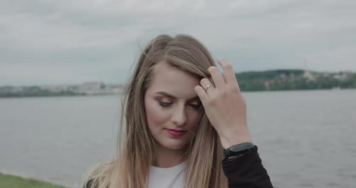 Attractive Young Woman Posing By the Water