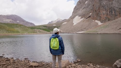 Hiker Enjoying Scenic Lake and Mountain Vista