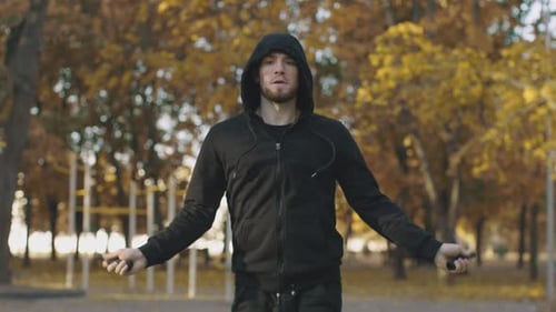 Man Jumping Rope in Autumnal Park