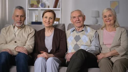 Senior Couples Smiling on Sofa