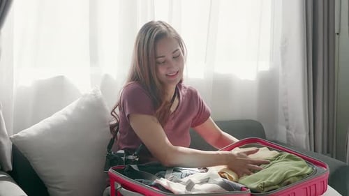 Smiling Woman Packing Suitcase for Travel Adventure