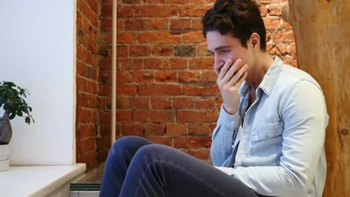 Man Crying, Sad and Covering Face Indoors