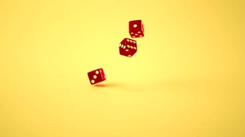 Colorful Dice Falling in Slow Motion on Yellow