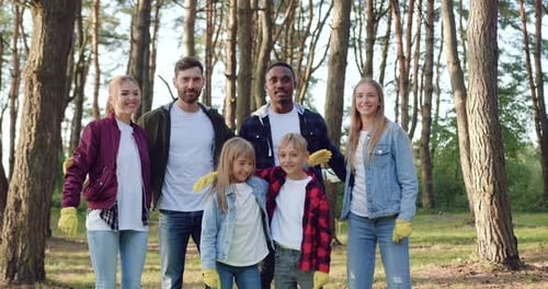Volunteers Which Standing in front of Camera with Arms Around Each other After Cleaning the Park
