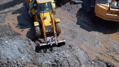 Aerial View of Excavator Loading Dirt into Truck