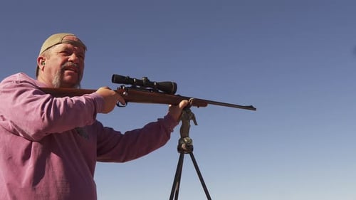 A man uses a bolt action rifle for target practice before deer hunting on the Colorado range. A spe