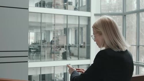 Businesswoman Using Smartphone in Office