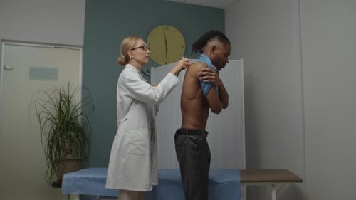Doctor Listens to Man's Breathing with Stethoscope
