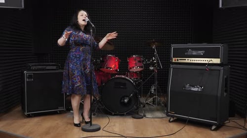 Woman singing in vocal studio