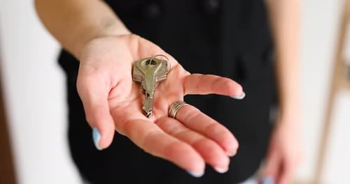 Real estate agent woman giving keys to customer after selling modern apartment