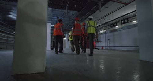 Anonymous Employees Working in Spacious Workshop