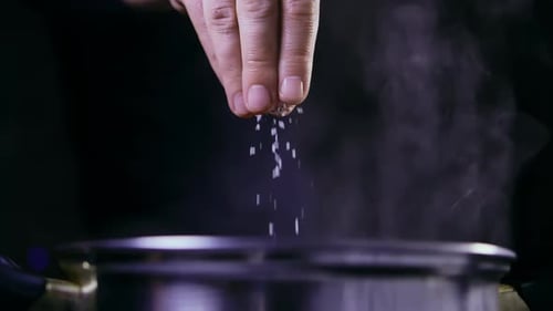 Man Salt Water Boiling in a Saucepan Dark Background