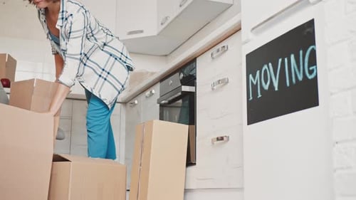 Happy Female Packing Item at Home