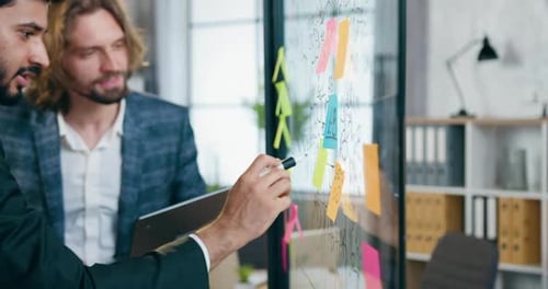 Men Collaborating on Strategy in Modern Office