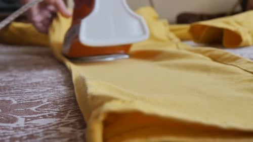 Clothing Iron Used on Yellow Garment