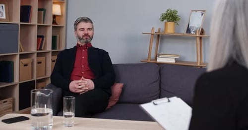 Man Talking During Therapy Session, Office Setting