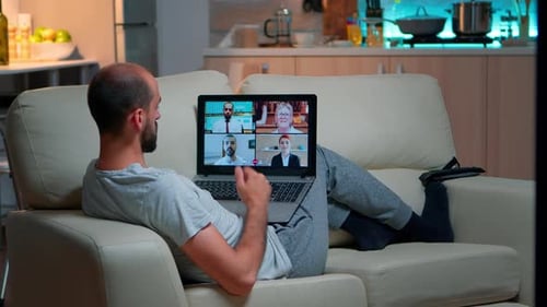 Man Video Conferencing With Coworkers at Home