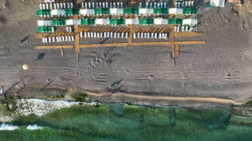 Empty sun loungers on the beach aerial view 4 K Turkey Alanya